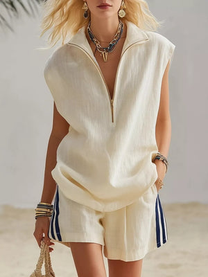 Cream sleeveless linen zip-neck top with matching shorts featuring navy side stripes.