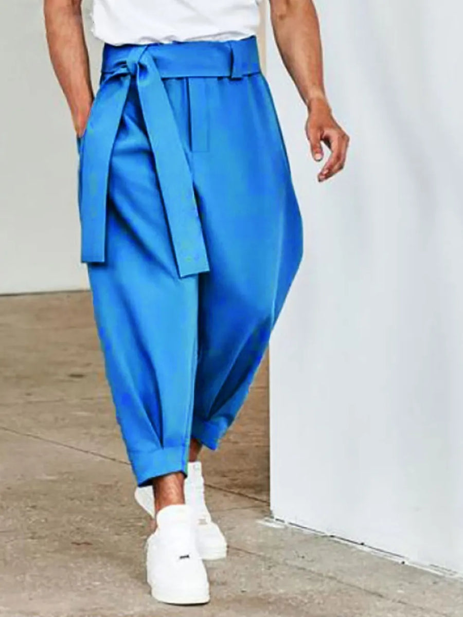 Blue balloon-leg wrap trousers with a tie belt and cuffed ankles.