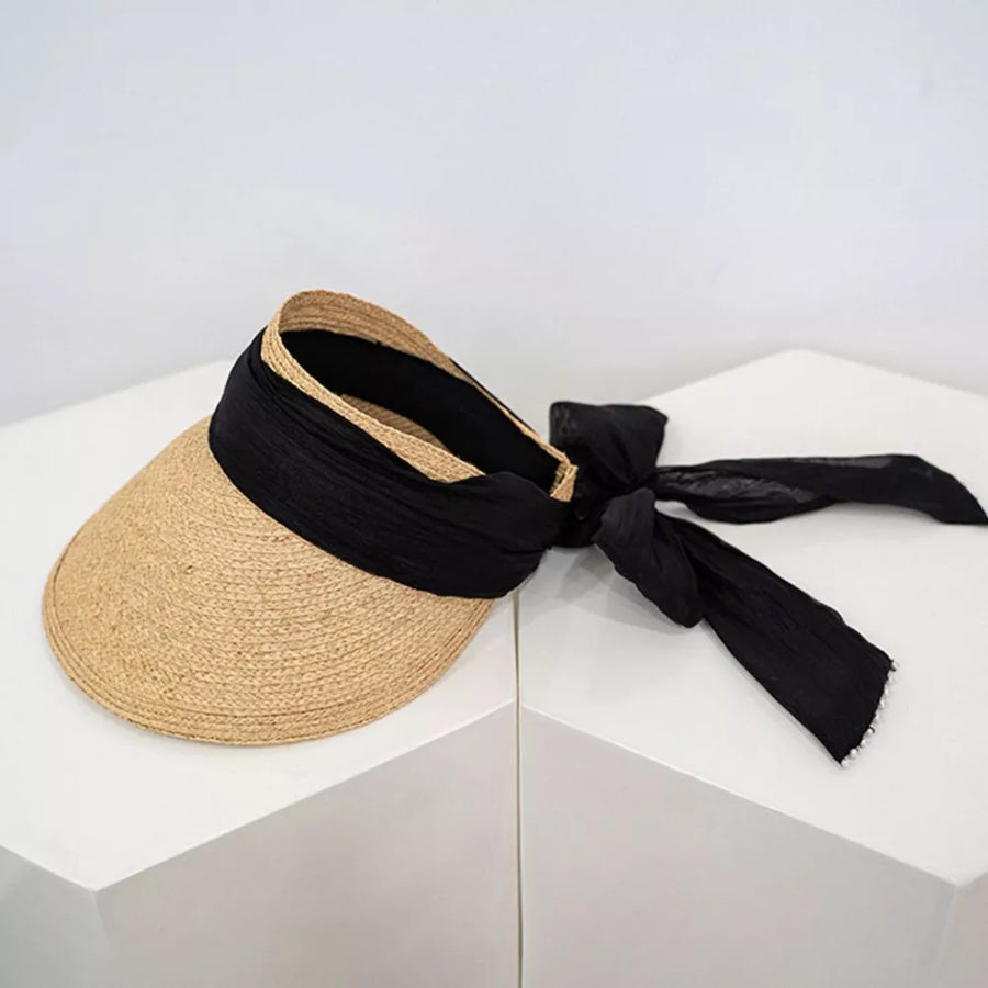 Straw visor hat in coffee color with black ribbon tie and beaded detail