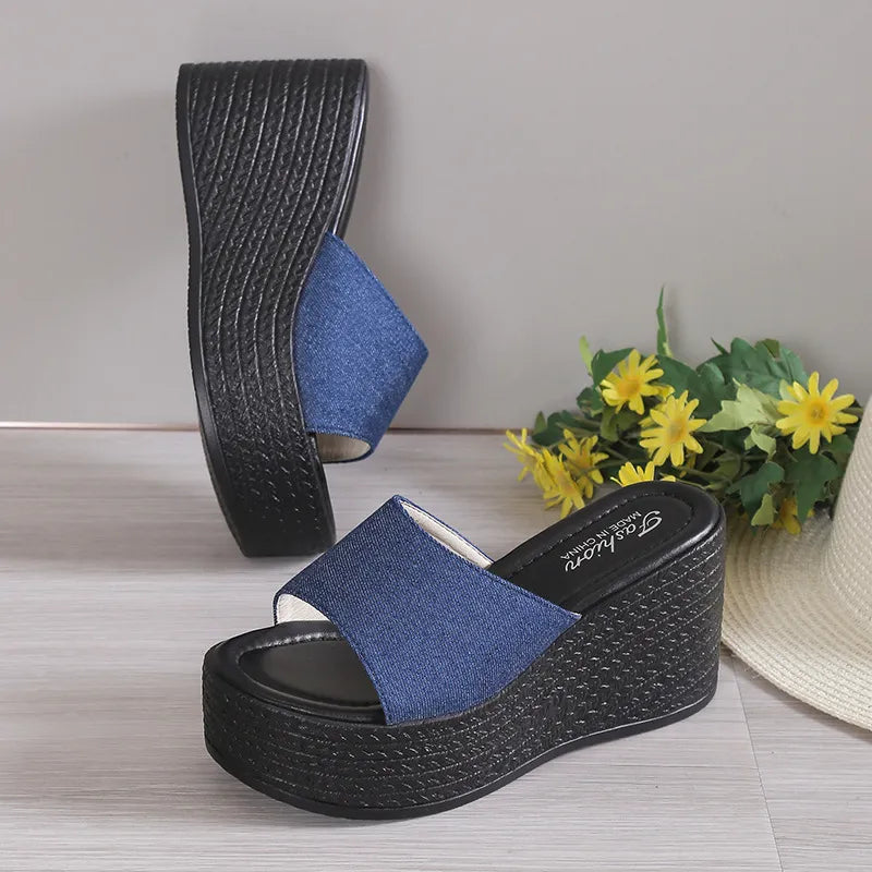 Denim platform wedge slides in dark blue with a black textured wedge sole.