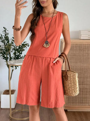 Orange-red relaxed fit tank top and shorts set with pockets, a round neckline, and a textured fabric.