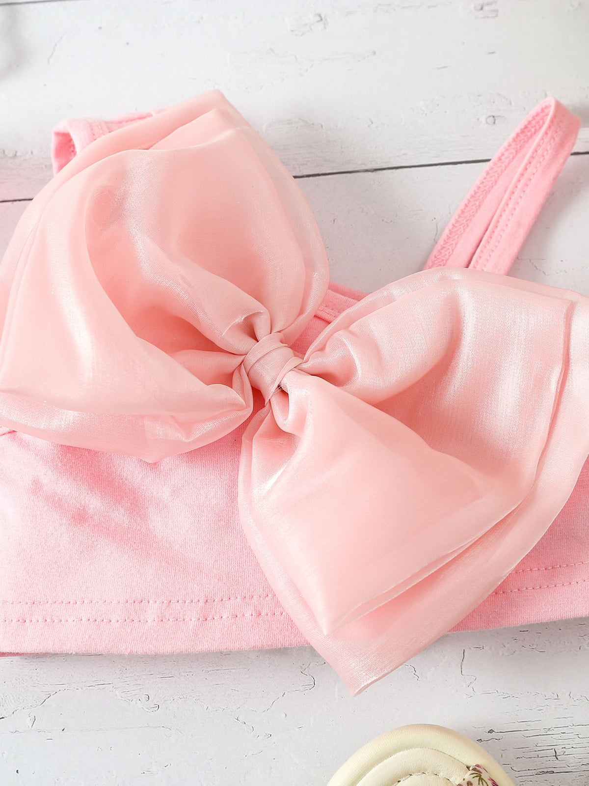 Pink tank top with large sheer bow detail
