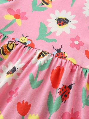 Pink cotton toddler dress with floral and insect print, featuring a ruffled hem.