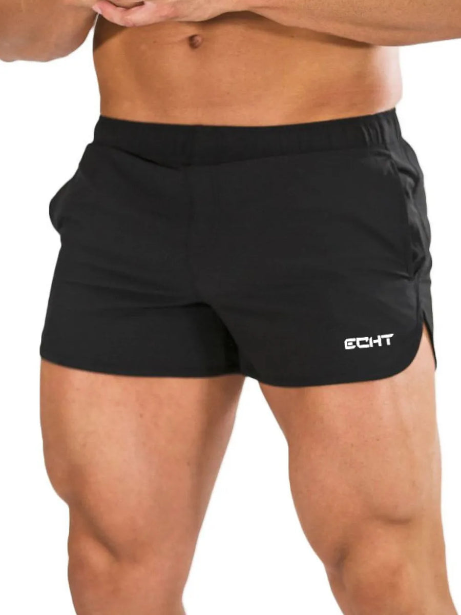 Black athletic shorts with quick-dry fabric and a white logo detail.