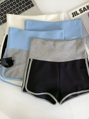 Black athletic shorts with gray contrast trim and waistband, shown with other colors.