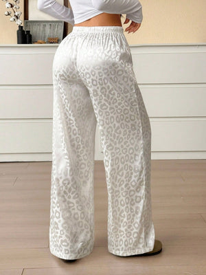 Wide leg leopard print satin loungewear pants with a drawstring waist.