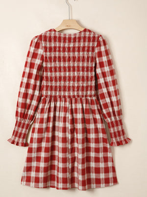 Red plaid cotton mini dress with smocked bodice, puff sleeves, and ruffled cuffs.