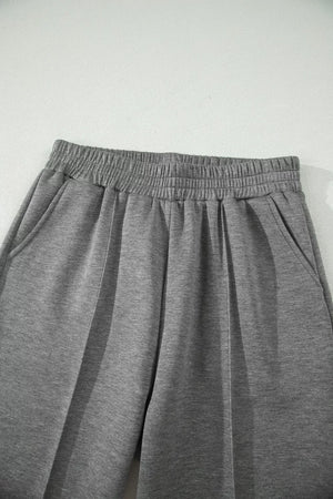 Chic dark gray wide-leg pants with elastic waistband and side pockets.