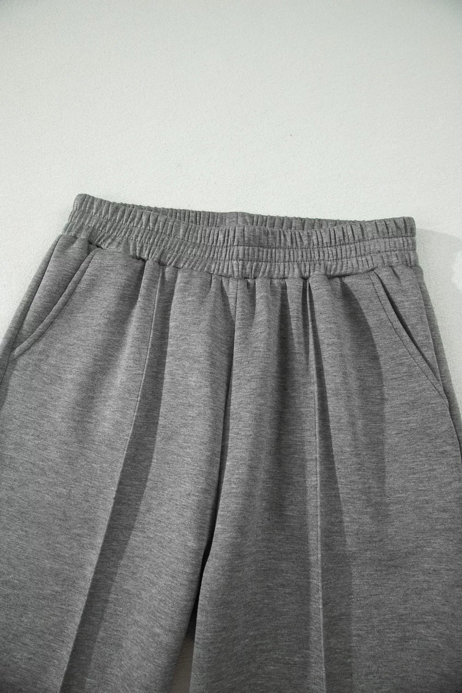Chic dark gray wide-leg pants with elastic waistband and side pockets.