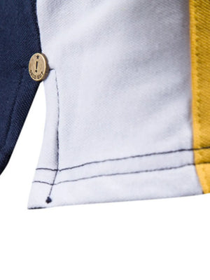 Colorblock polo shirt with navy, white, and yellow panels and a gold button detail.