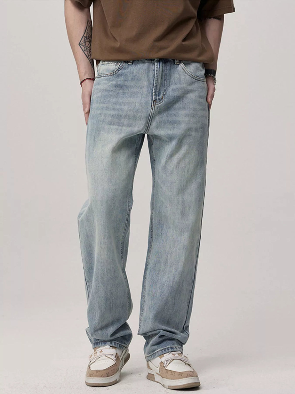 Men's light blue relaxed fit wash jeans with a casual, comfortable denim style.