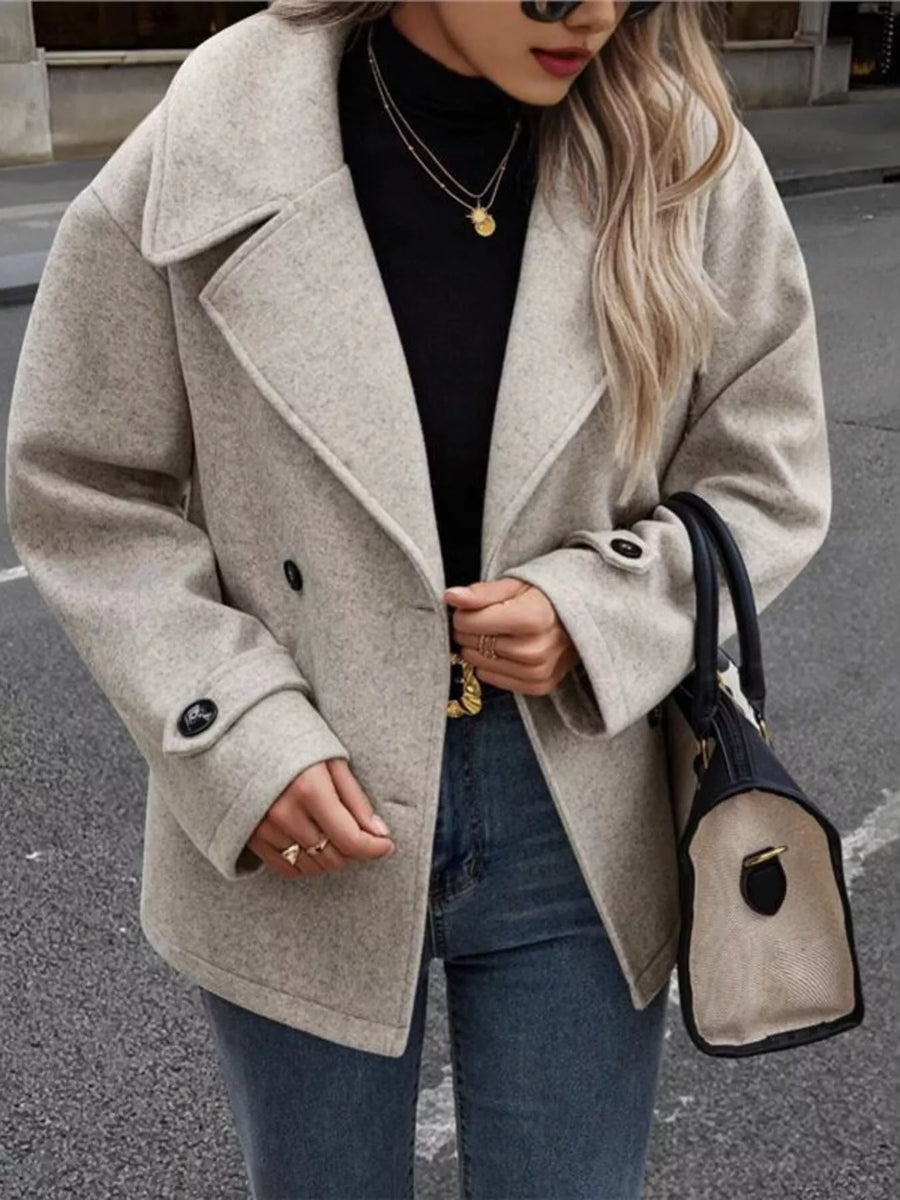 Light gray double-breasted wool blend pea coat with button details and wide lapels.