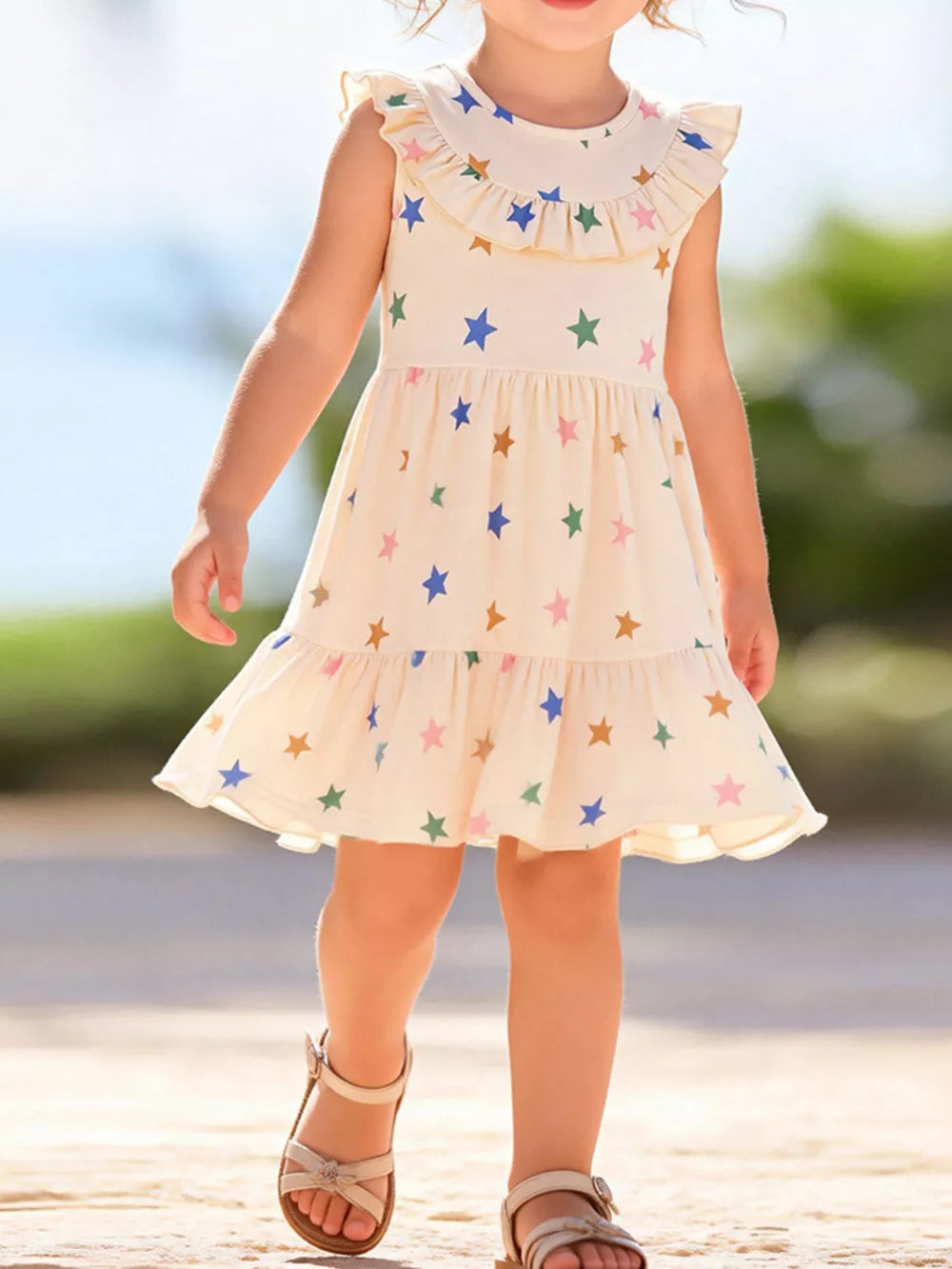 Toddler dress in beige cotton with a whimsical star print, ruffled neckline and hem