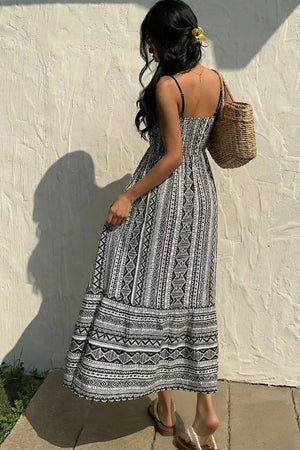Black and white geometric print maxi cami dress with spaghetti straps and a tiered skirt.