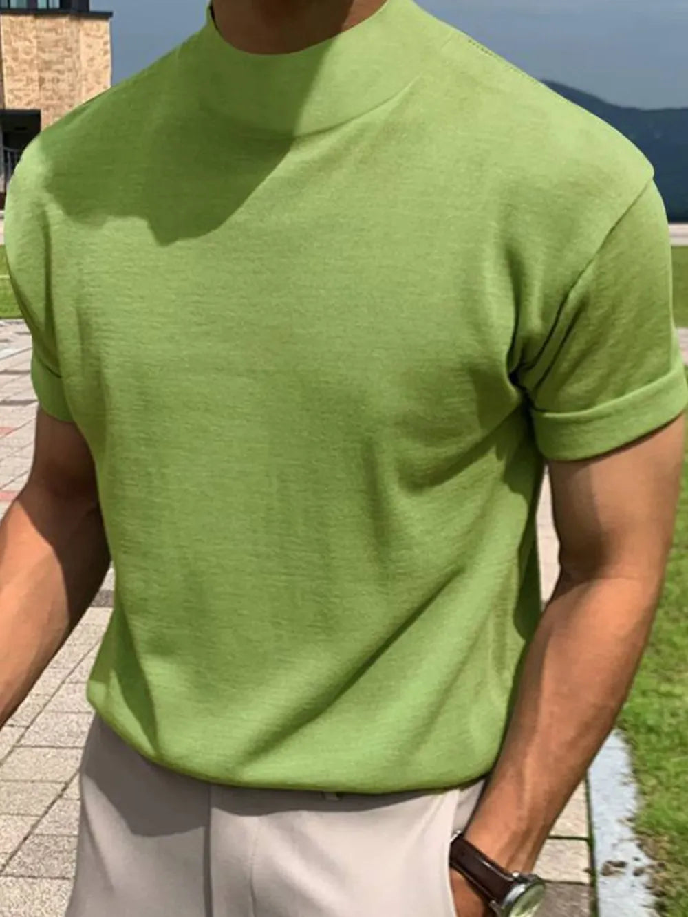 Matcha green knit tee with mock neck and rolled short sleeves.