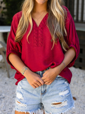 Braided V-neck half sleeve blouse in deep red with puffed sleeves.