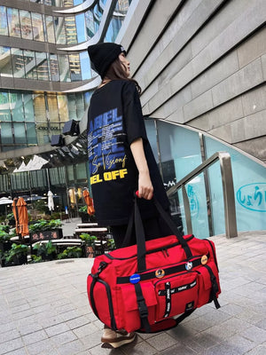Red duffel bag with multiple pockets and straps, perfect for gym or travel.