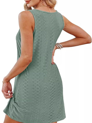 Green eyelet tank dress with twisted hem detail.
