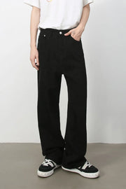 Black wide-leg rigid denim trousers with a casual fit.