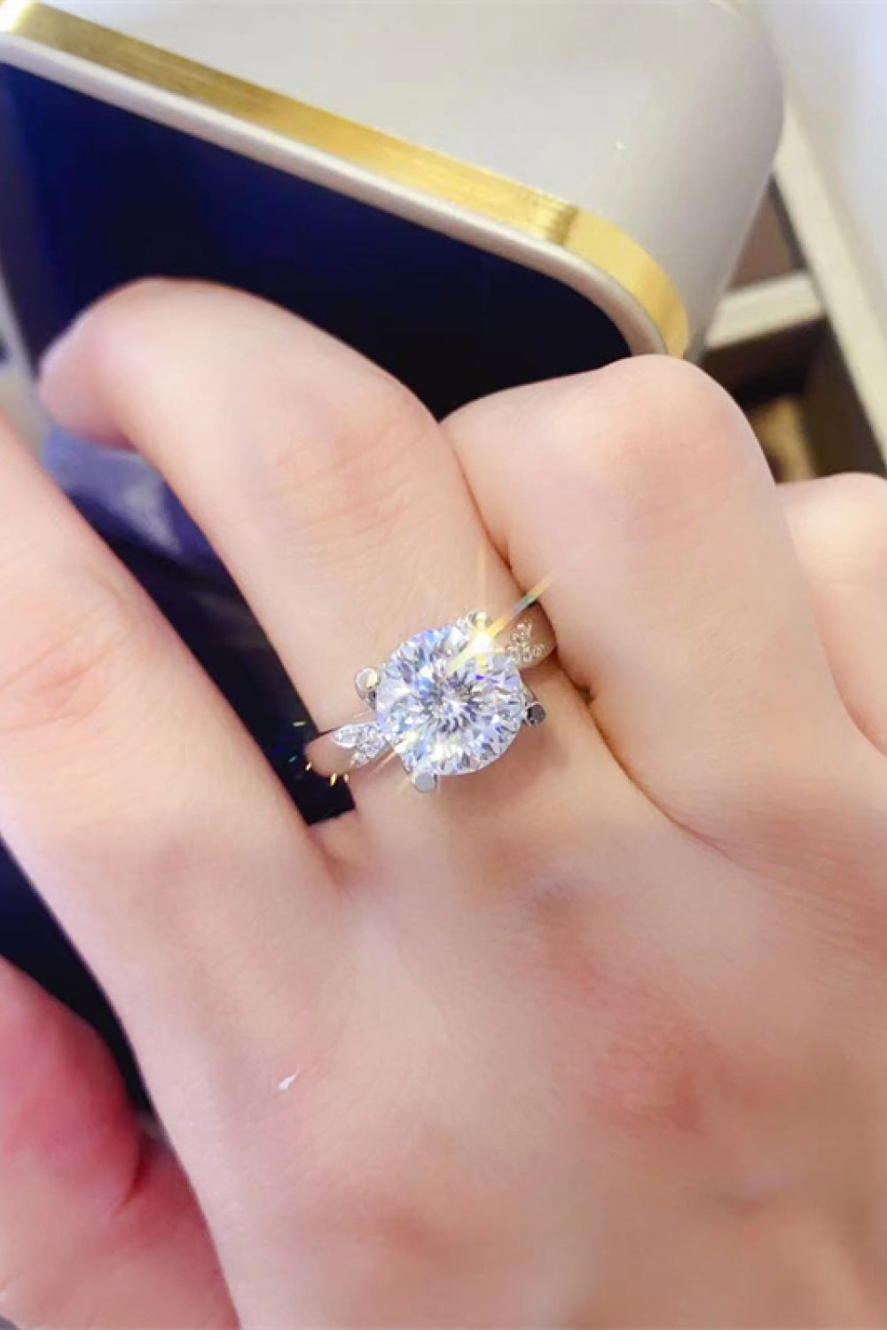 Sterling silver ring with a large round solitaire diamond surrounded by a halo of smaller stones.