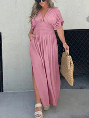 Pink V-neck dolman sleeve maxi dress with smocked waist and side slits.
