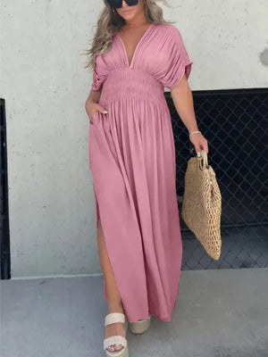 Pink V-neck dolman sleeve maxi dress with smocked waist and side slits.