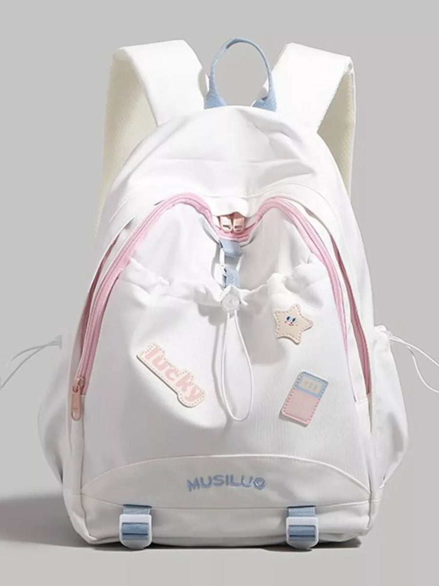 White drawstring backpack with pink trim, cute patches, and blue accents.