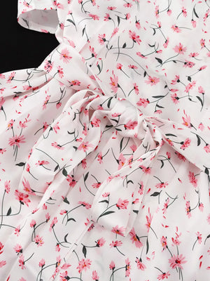 White floral print dress with pink flowers and a tie waist.