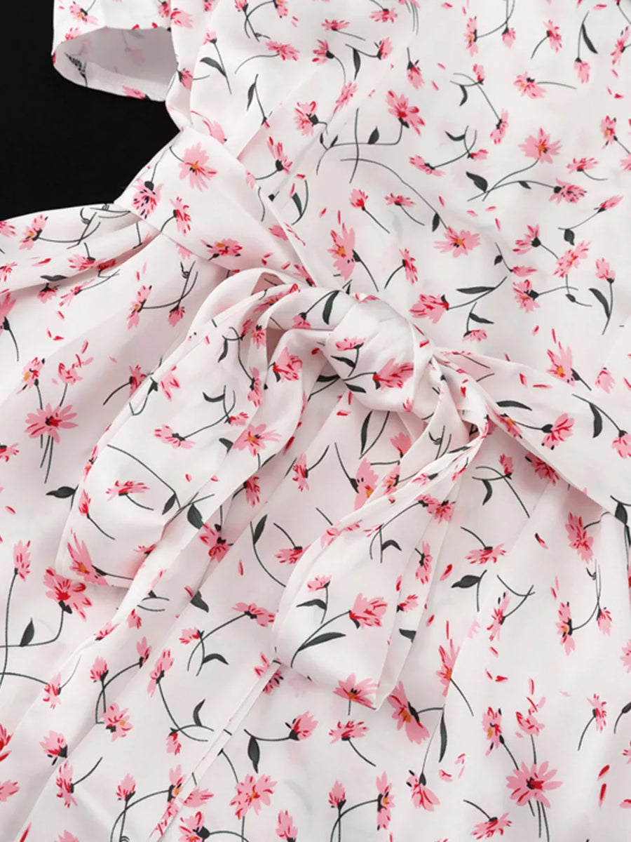 White floral print dress with pink flowers and a tie waist.