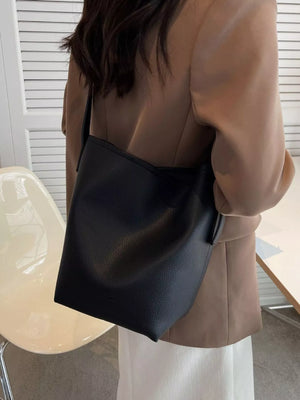 Black pebbled PU leather shoulder bag with a minimalist design.