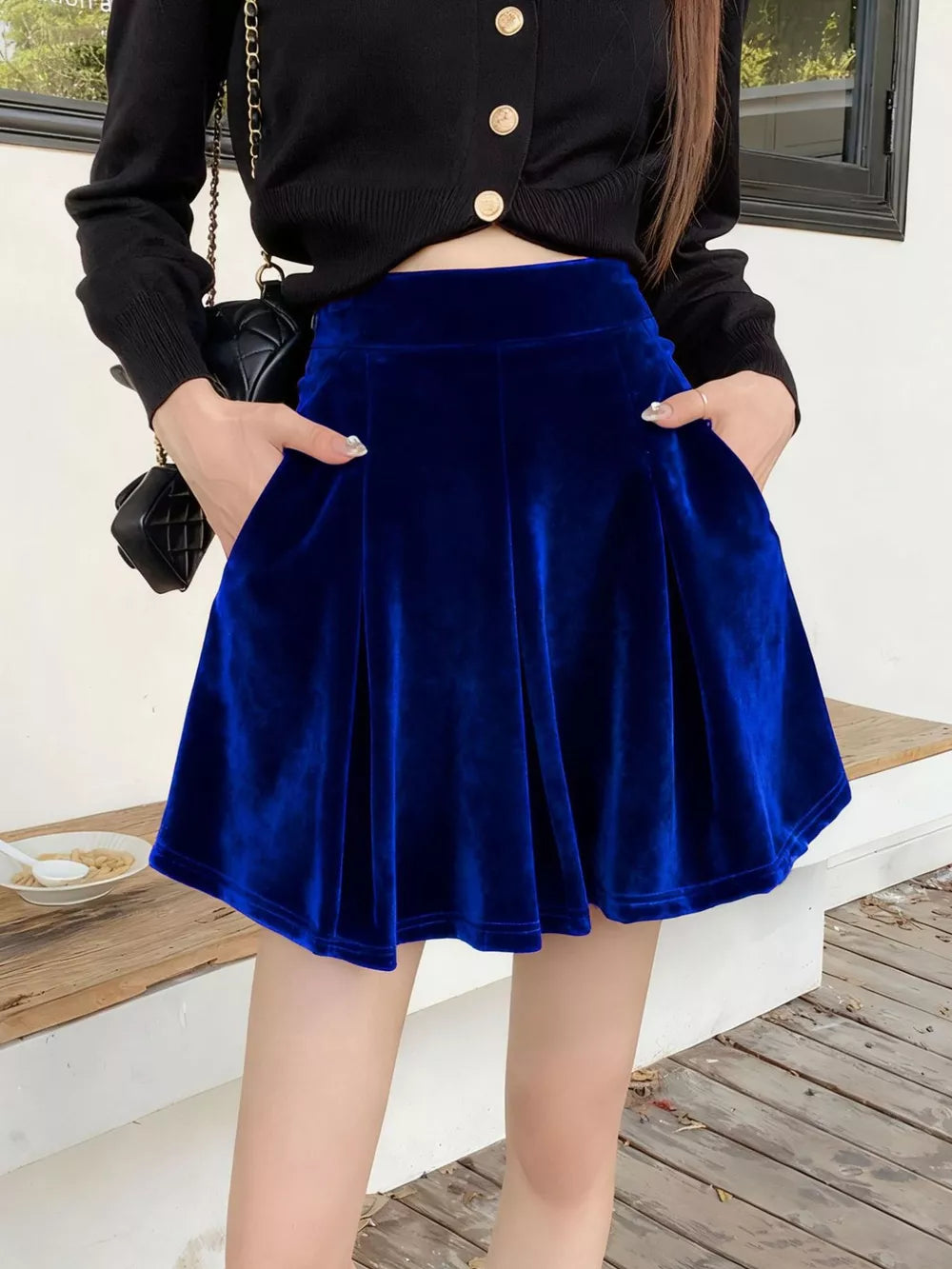 Royal blue velvet A-line skort with pockets and a pleated hem.