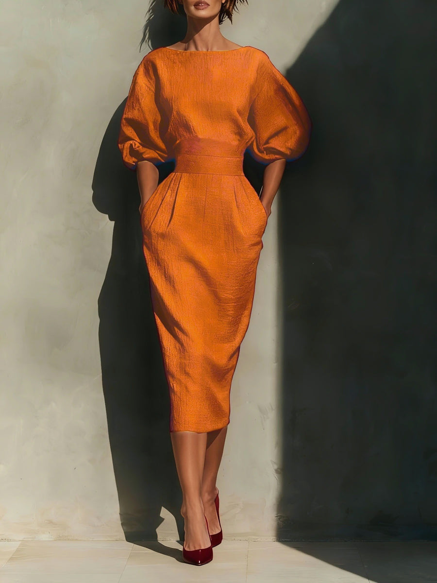 Orange midi dress with puff sleeves, boat neck, and pockets.