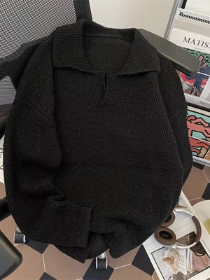 Black textured knit polo collar sweater with a relaxed fit and v-neck detail.