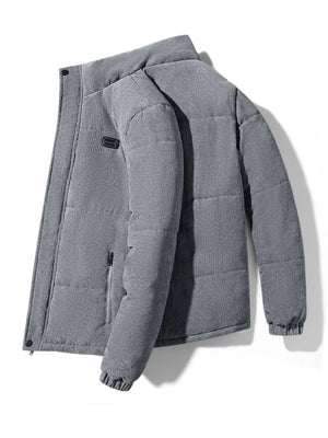 Men's grey corduroy puffer jacket with a zip pocket and elastic cuffs.