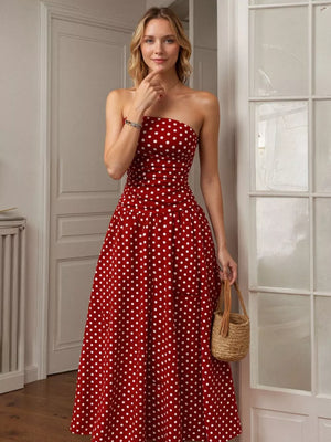 Red polka dot strapless maxi gown with a cinched waist and full skirt.