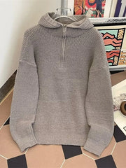 Gray knit hoodie with half-zip neckline and ribbed details.
