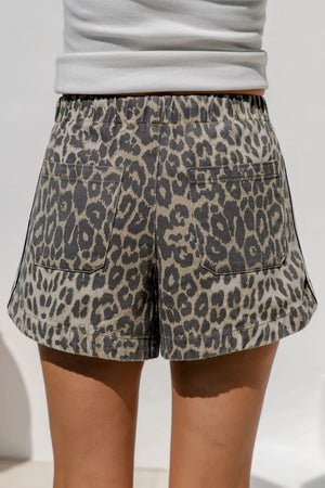 Leopard print denim shorts with drawstring waist and back pockets.