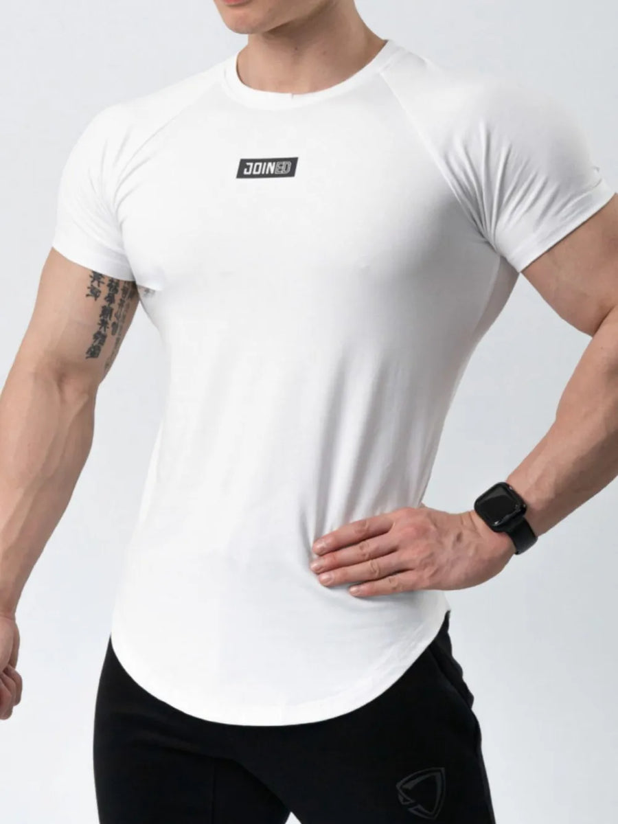 White performance raglan tee with black logo detail and curved hem