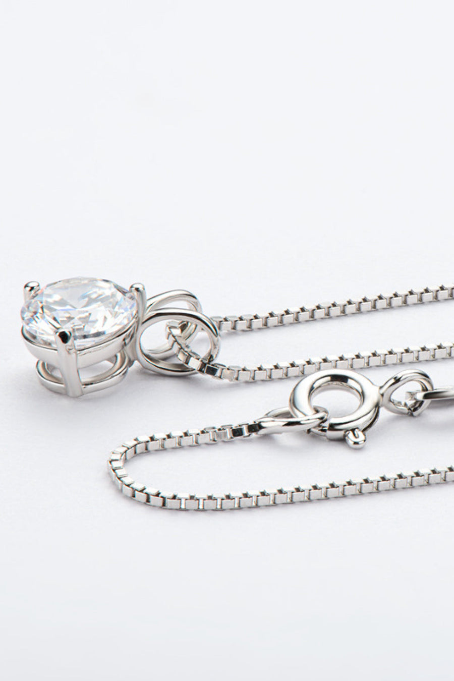 Silver solitaire moissanite pendant necklace with box chain and clasp detail