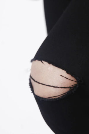 Dark skinny jeans with distressed knee detail