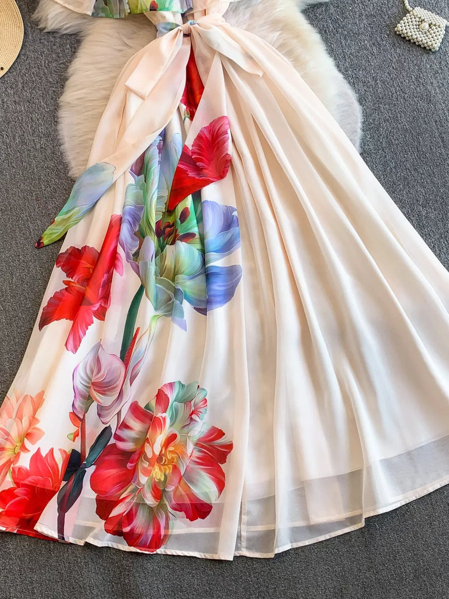 Botanical off-shoulder A-line dress in light pink with vibrant floral print and belted detail.