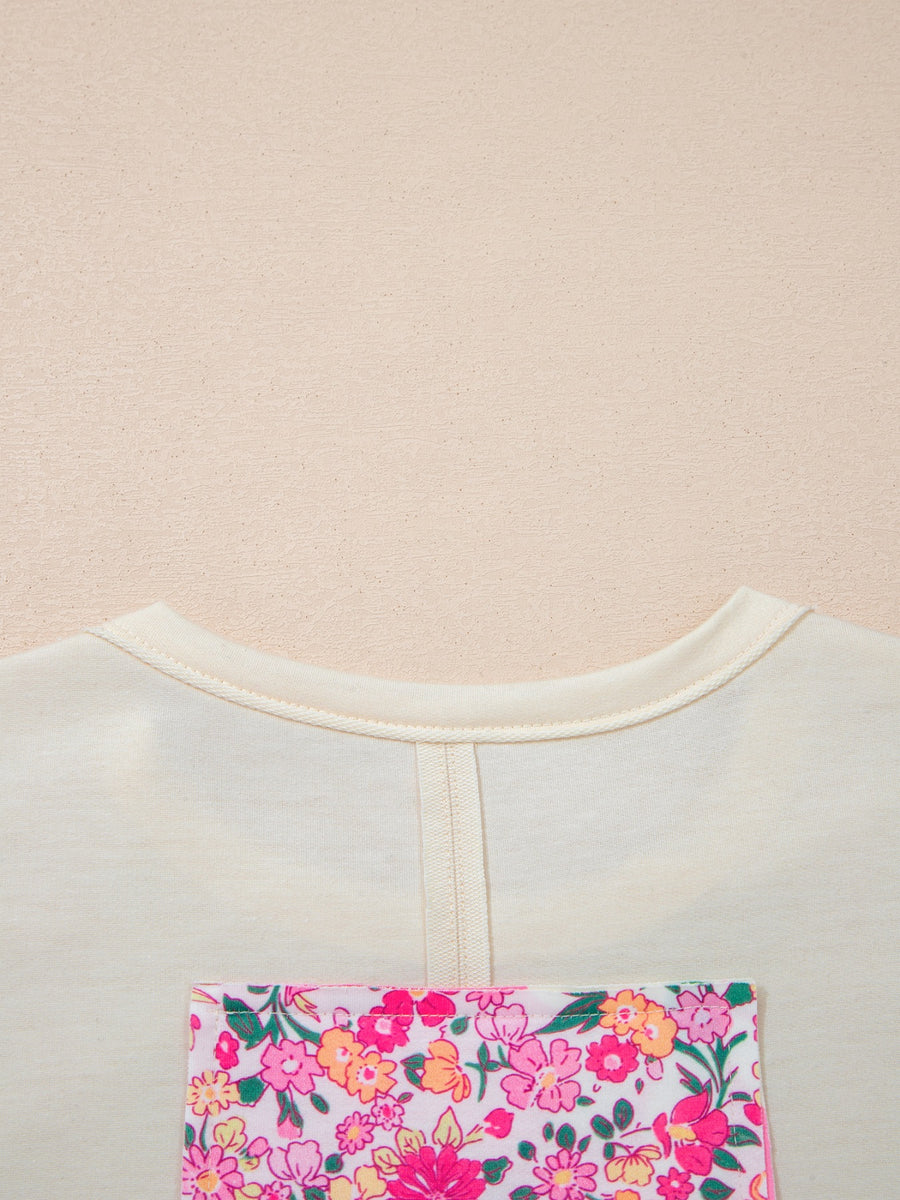 Cream cotton crew neck t-shirt with a colorful floral chenille patch pocket detail.