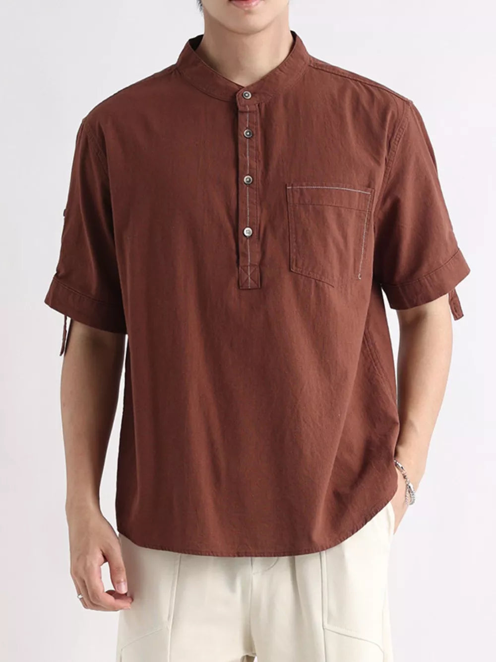Brown cotton short sleeve henley shirt with button detail and chest pocket.