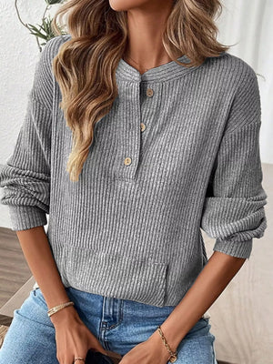 Gray ribbed long-sleeve top with button detail and a front pocket.