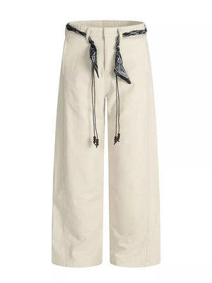 Cream white maternity pants with wide legs and a beaded drawstring belt.