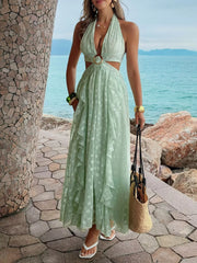 Light green textured ruffled halter neck maxi dress with cutouts and a ring detail.