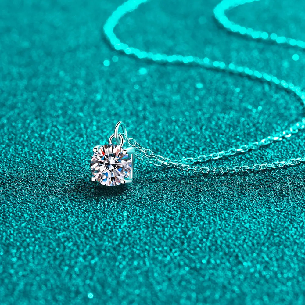 Solitaire moissanite pendant necklace in silver with a delicate chain.