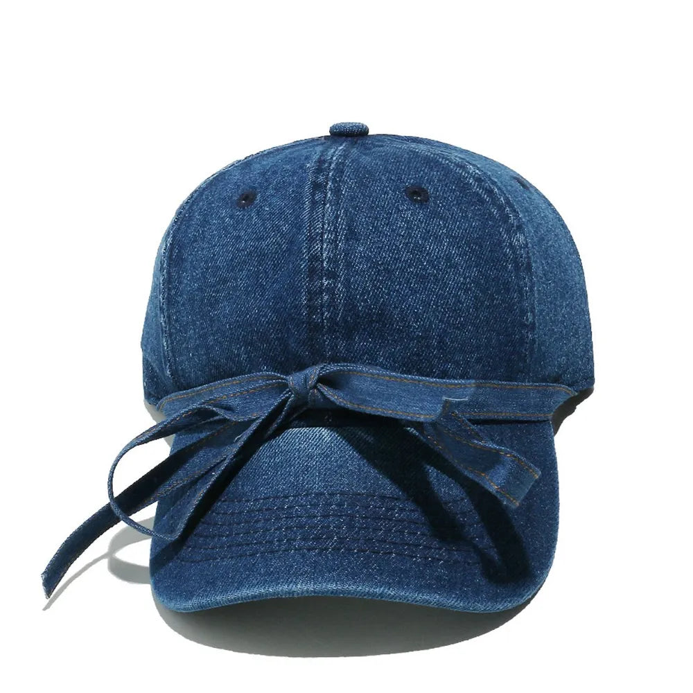 Denim baseball cap in navy with a bow tie detail.