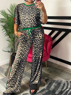 Leopard print loungewear set with green trim, featuring a short sleeve top and wide leg pants.