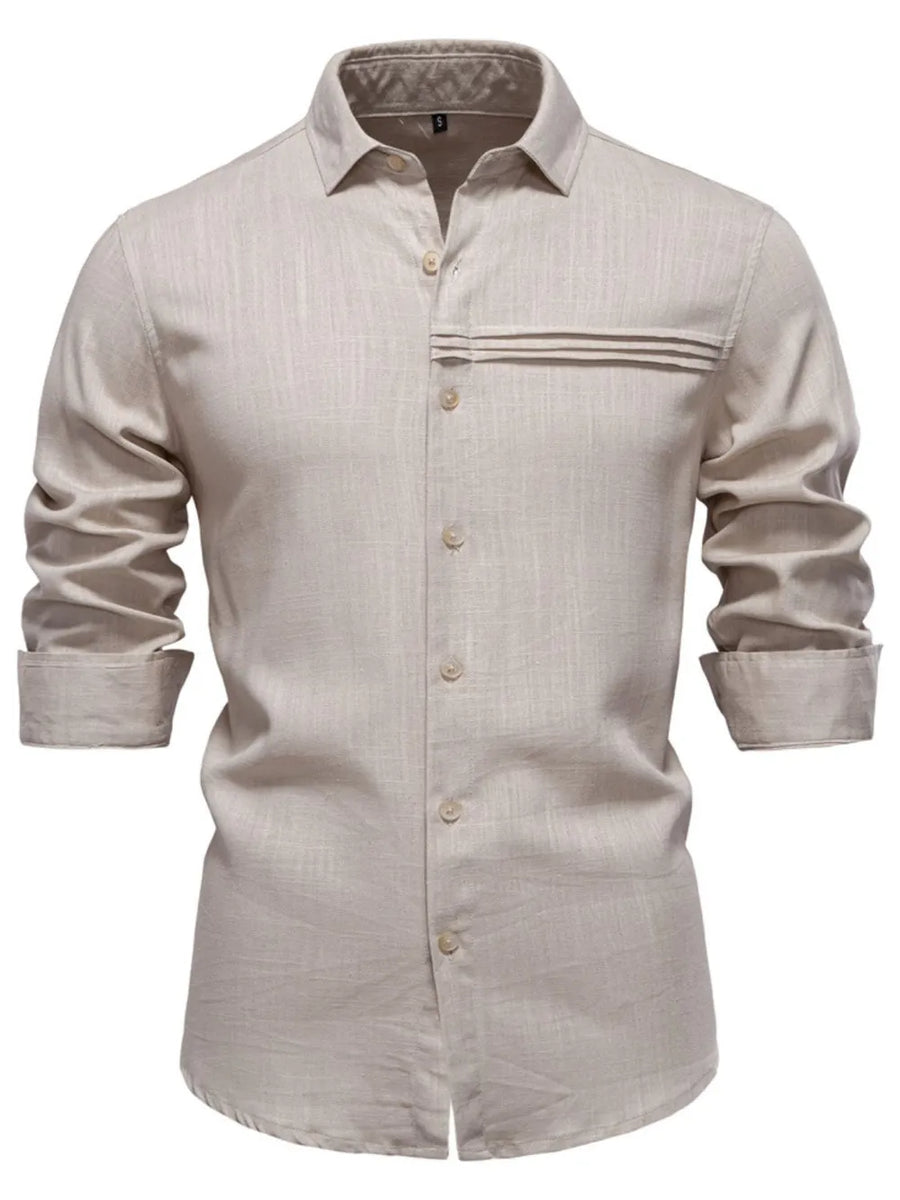 Light gray linen shirt with buttoned front, collar, and pleated pocket detail.